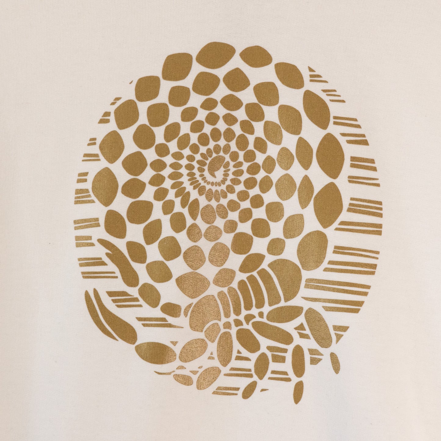 Close up of the design. A white hoodie sweatshirt with an illustrated design of a metallic gold scorpion with its tail coiled into a spiral.